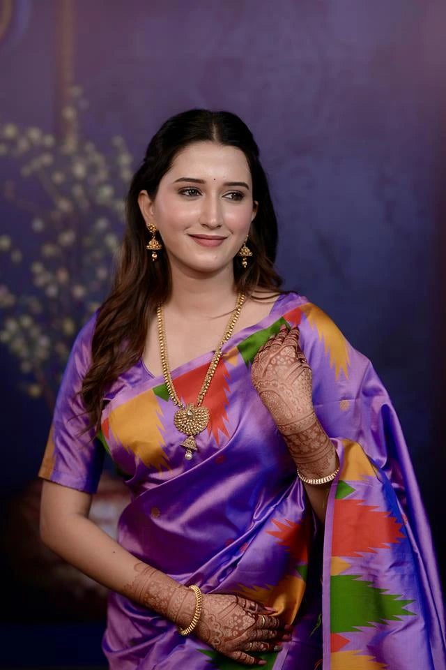 Woman in a colorful saree with a purple background